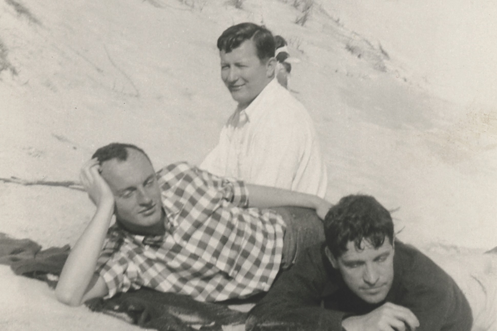 Black and white photo of Frank O'Hara, Hal Fondren, and Fairfield Porter on the beach in 1954.