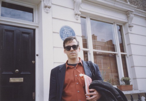 David Trinidad in front of Sylvia Plath's apartment