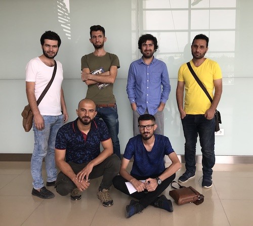 The six poets poets pose before their reading (L to R, front row: Emad, Zêdan; back row: Sardan, Saad, Zaeem, Jaff). Photo by Alana Marie Levinson LaBrosse.