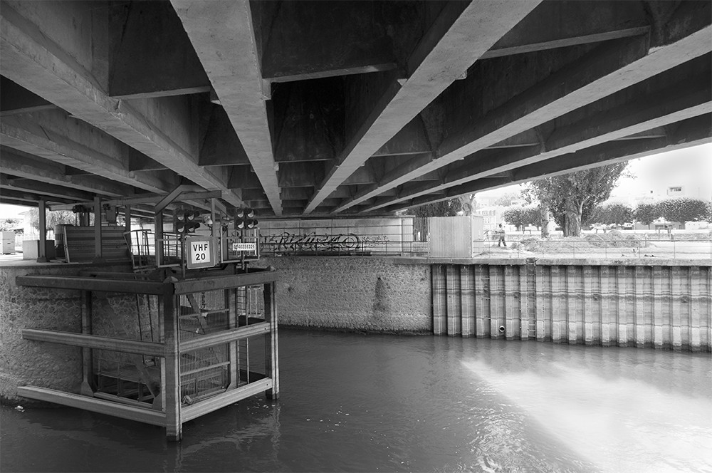 Photograph of graffiti under bridge.