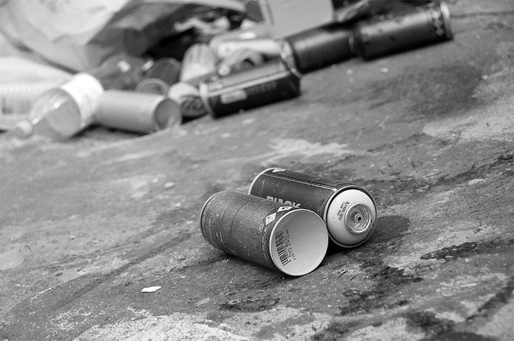 Photograph of graffiti and spray cans.