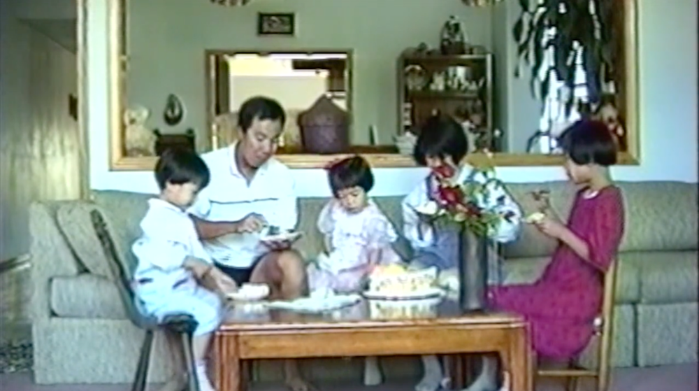 Diana Khoi Nguyen, film still of family eating birthday cake