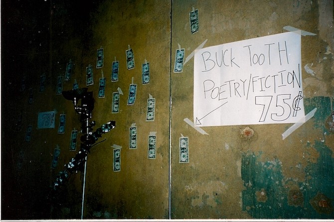 Dollar bills taped to a wall with a poem written on them.