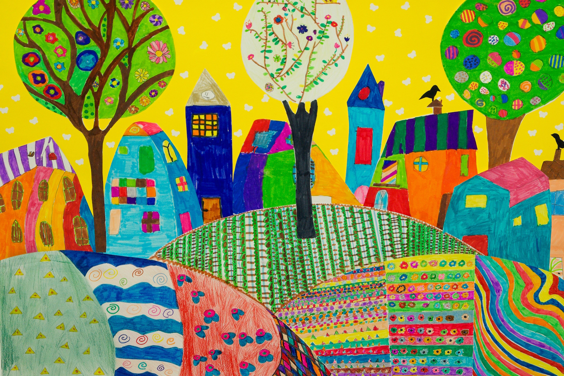 Image of colorful children's drawing, featuring several houses and a park.