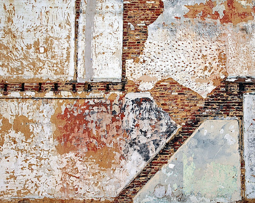Photo of an exterior wall, layered, overlaid, scraped