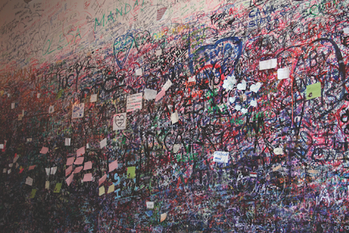 Photo of lovers' graffiti layers on walls of entrance to Juliet's house in Verona.
